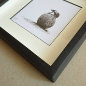 Dung beetle artwork with black wood frame