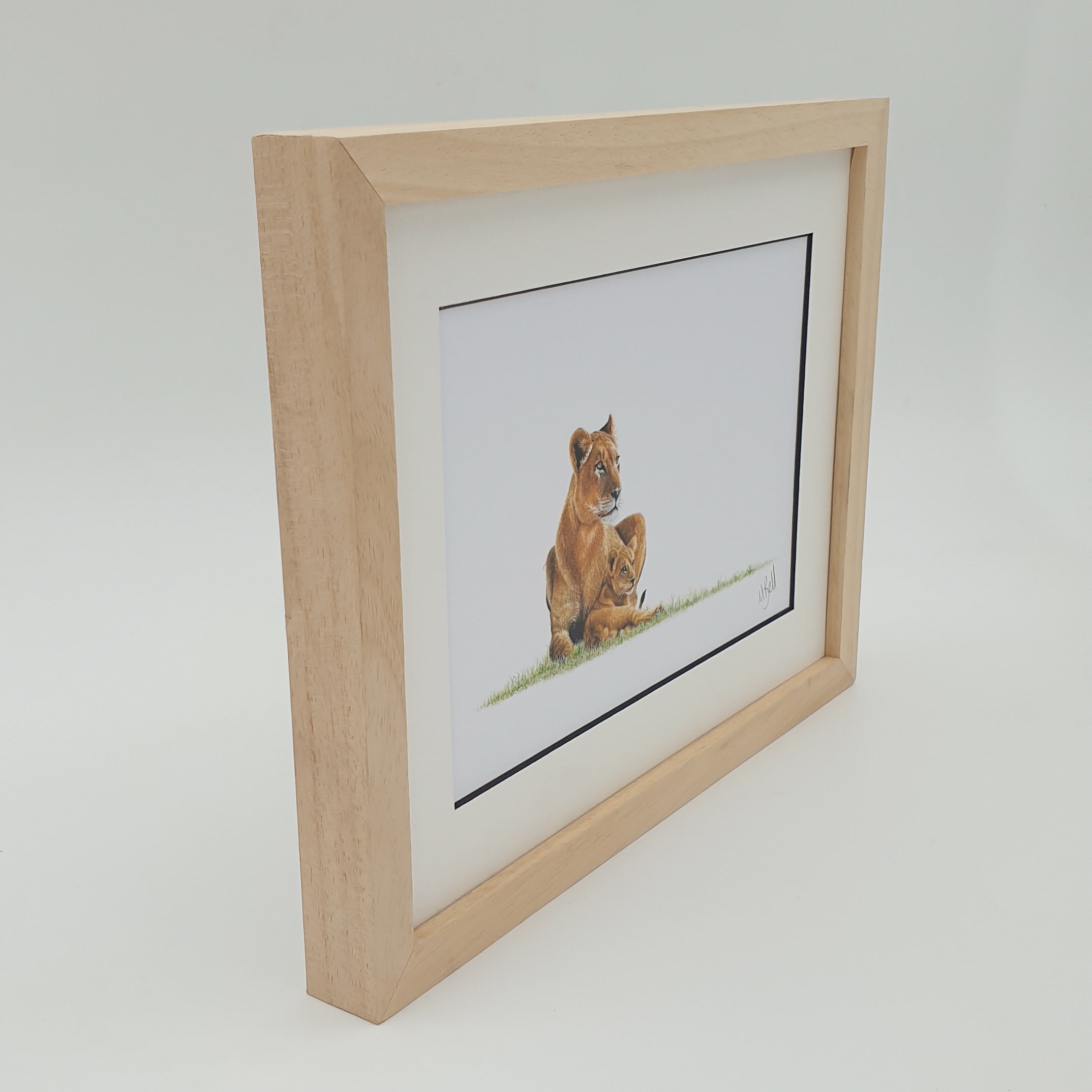 African lioness with a cub framed artwork with natural wood frame