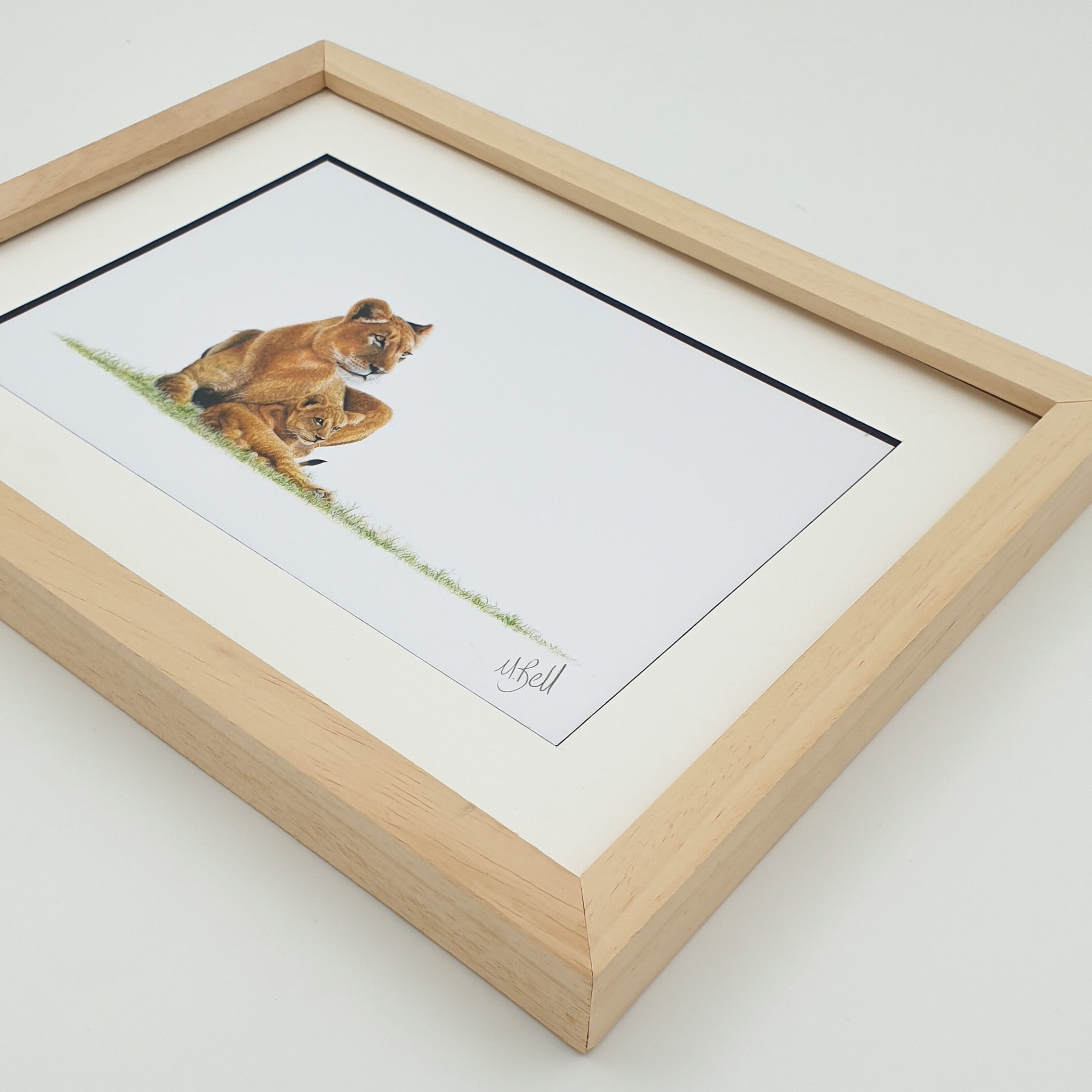 African lioness with a cub framed artwork with natural wood frame