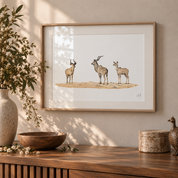 Ash framed artwork of 3 kudus hanging on the wall in a neutral tone bright interior