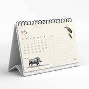 Tabletop calendar for July 2020 with illustrations on a white background