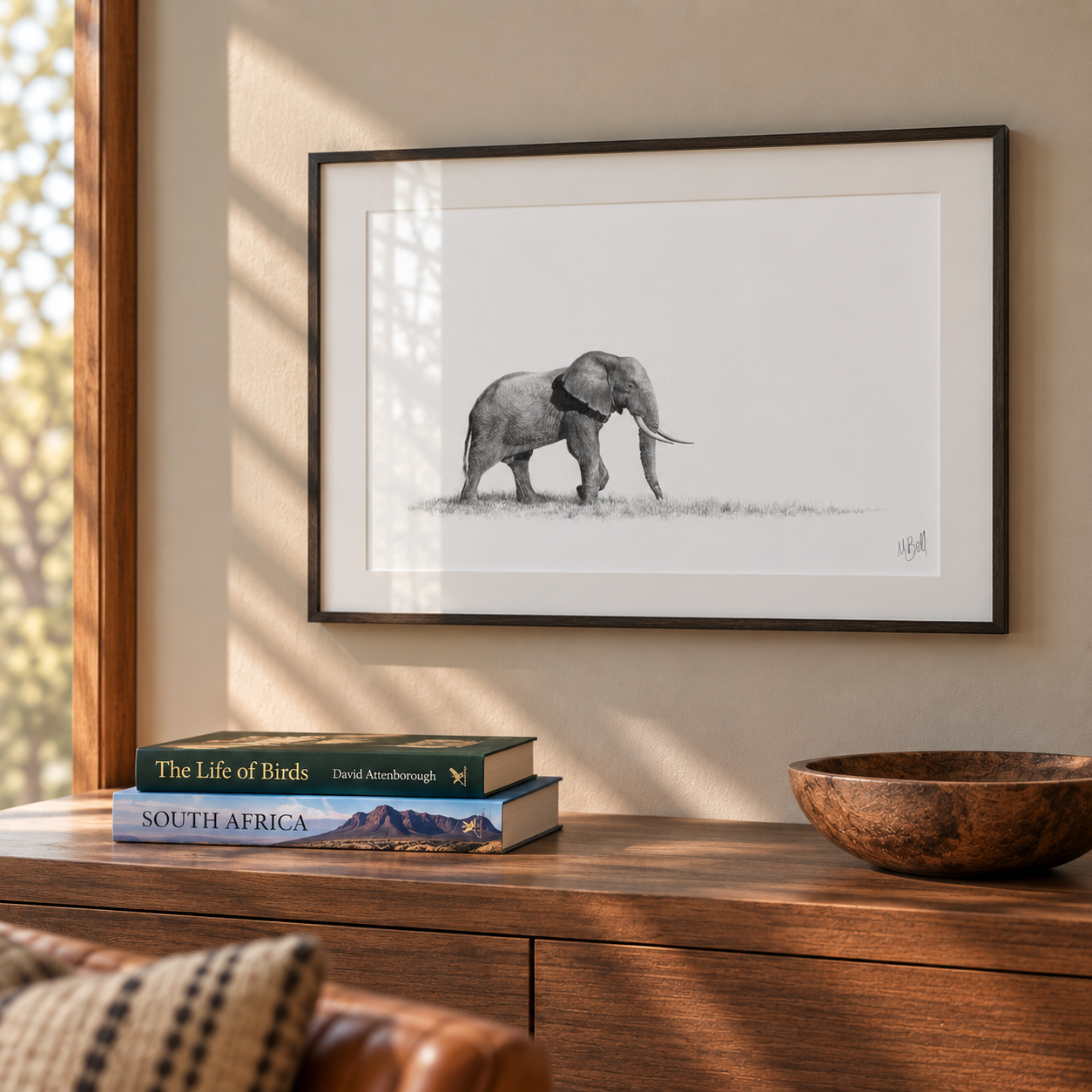 African elephant framed artwork with a black frame hanging on the wall