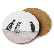 Wooden coasters with Matthew Bell's penguin drawings on them