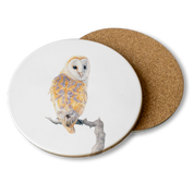 Round wooden coaster with a drawing of a barn owl and a white background