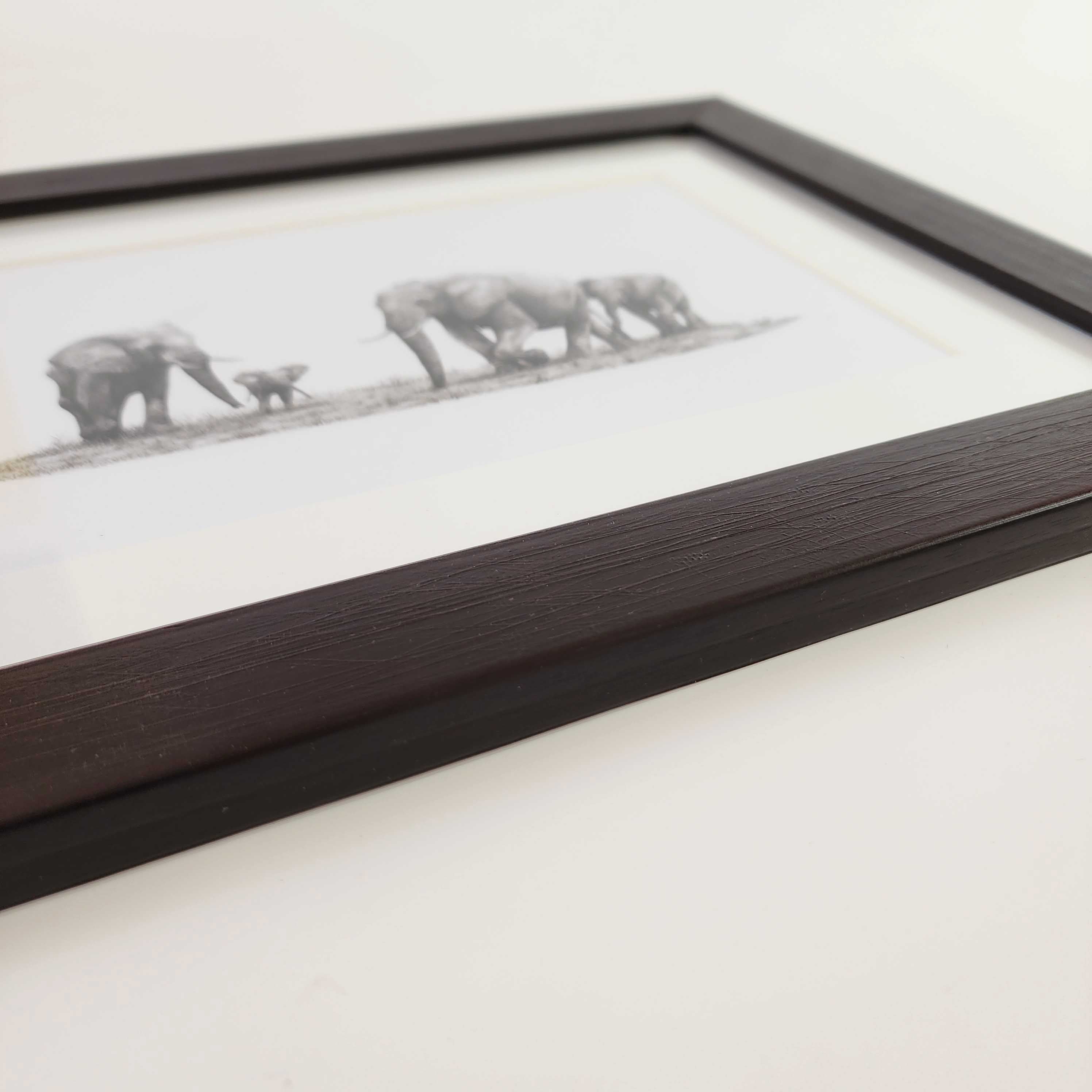 African elephants family artwork with a brown frame