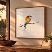 A framed art print of a european bee-eater bird perched on a branch, displayed on a textured beige wall above a wooden console table with a bowl and a plant.