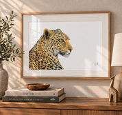 Leopard framed artwork hanging on the wall above a wooden counter