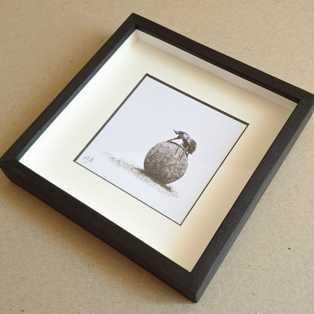 Dung beetle artwork with black wood frame