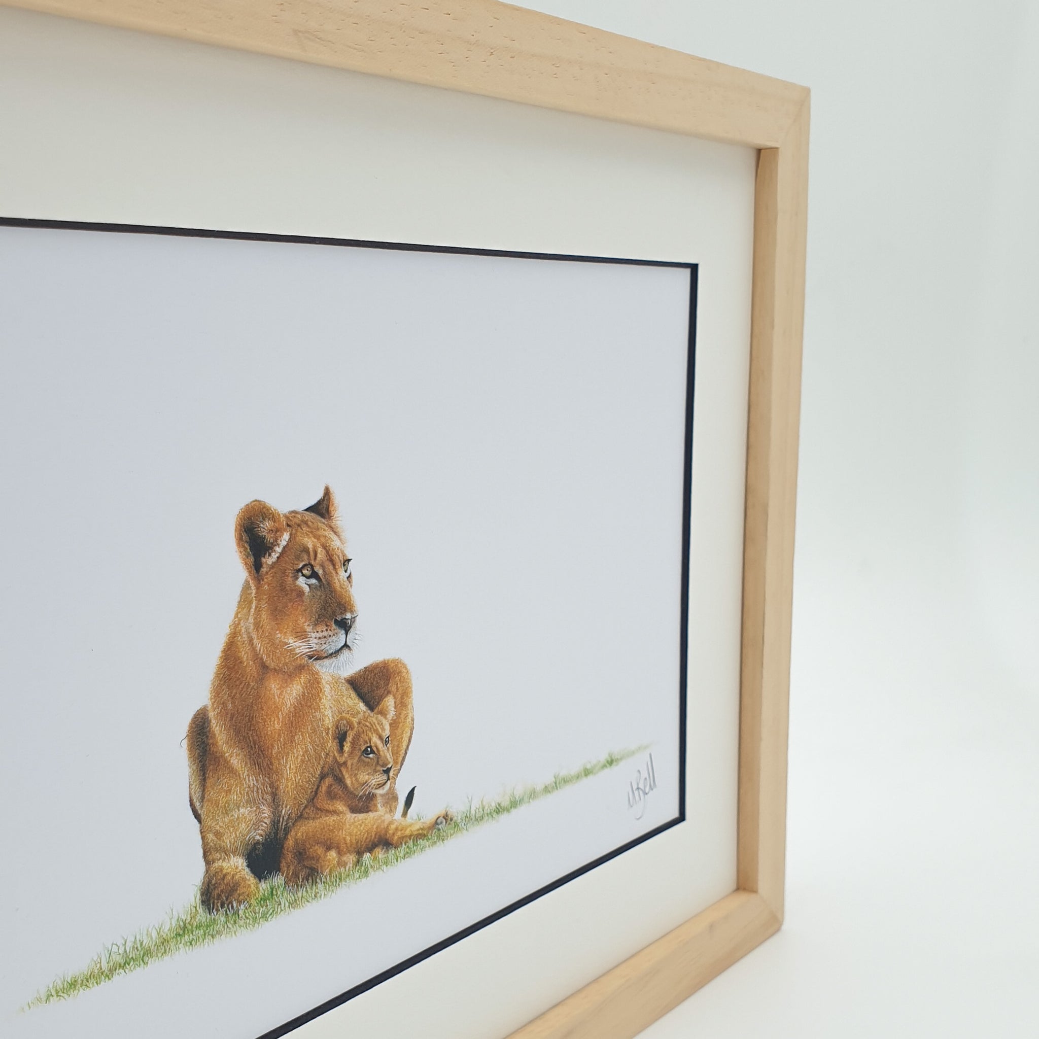 African lioness with a cub framed artwork with natural wood frame